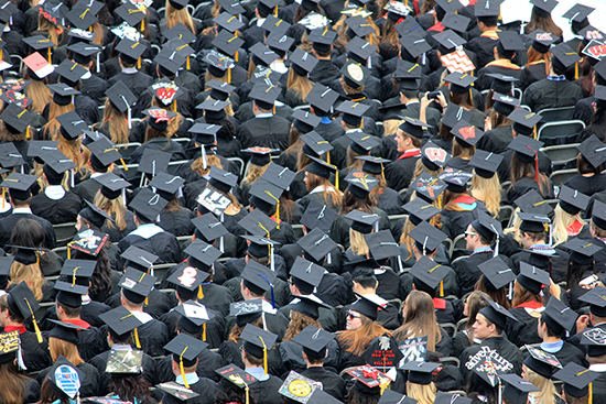 Photo of a crowd of graduates wearing caps and gowns